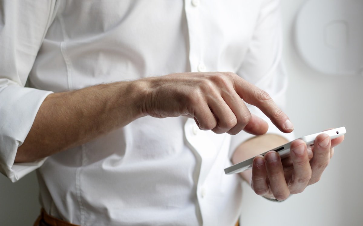 Business professional effortlessly sending website updates via mobile text message